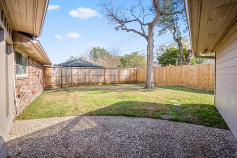 a view of backyard with swimming pool and outdoor space