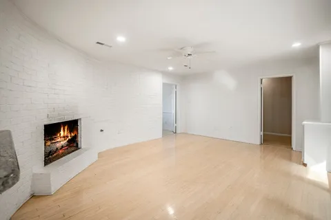a view of an empty room with a kitchen