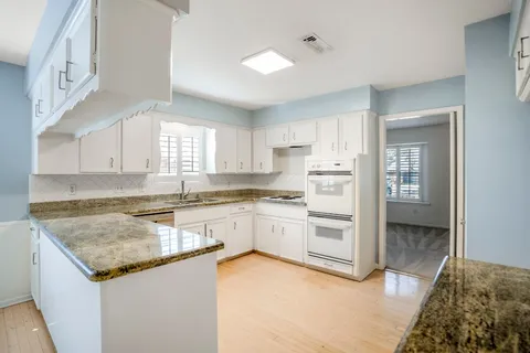 a kitchen with a stove a sink and a refrigerator