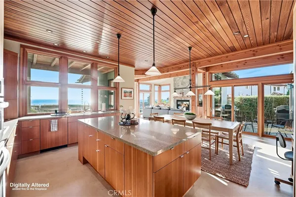 a large dining hall with stainless steel appliances granite countertop a stove and cabinets