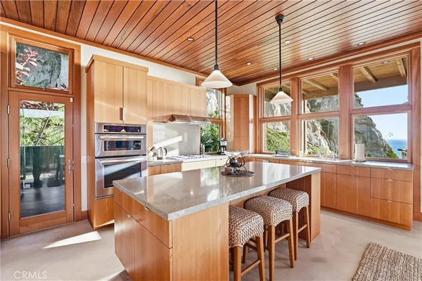 a kitchen with a stove a sink and cabinets
