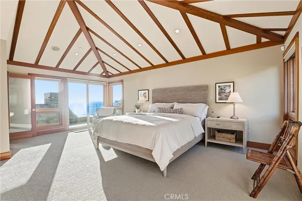 a large bedroom with a bed and a large window with outer view