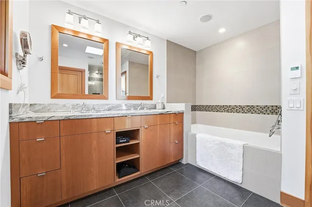 a bathroom with a granite countertop sink and a shower