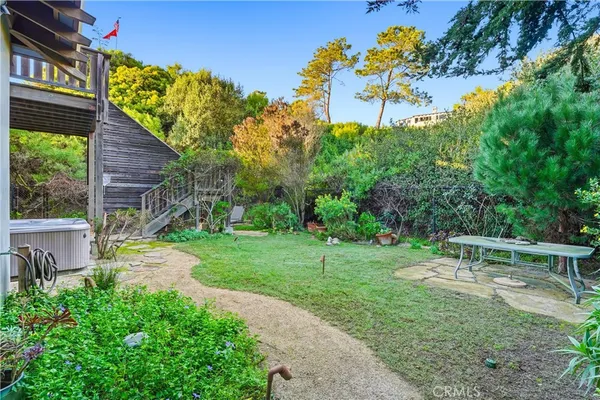 a view of a backyard with plants and a patio