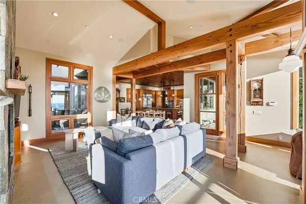 a living room with furniture and large windows