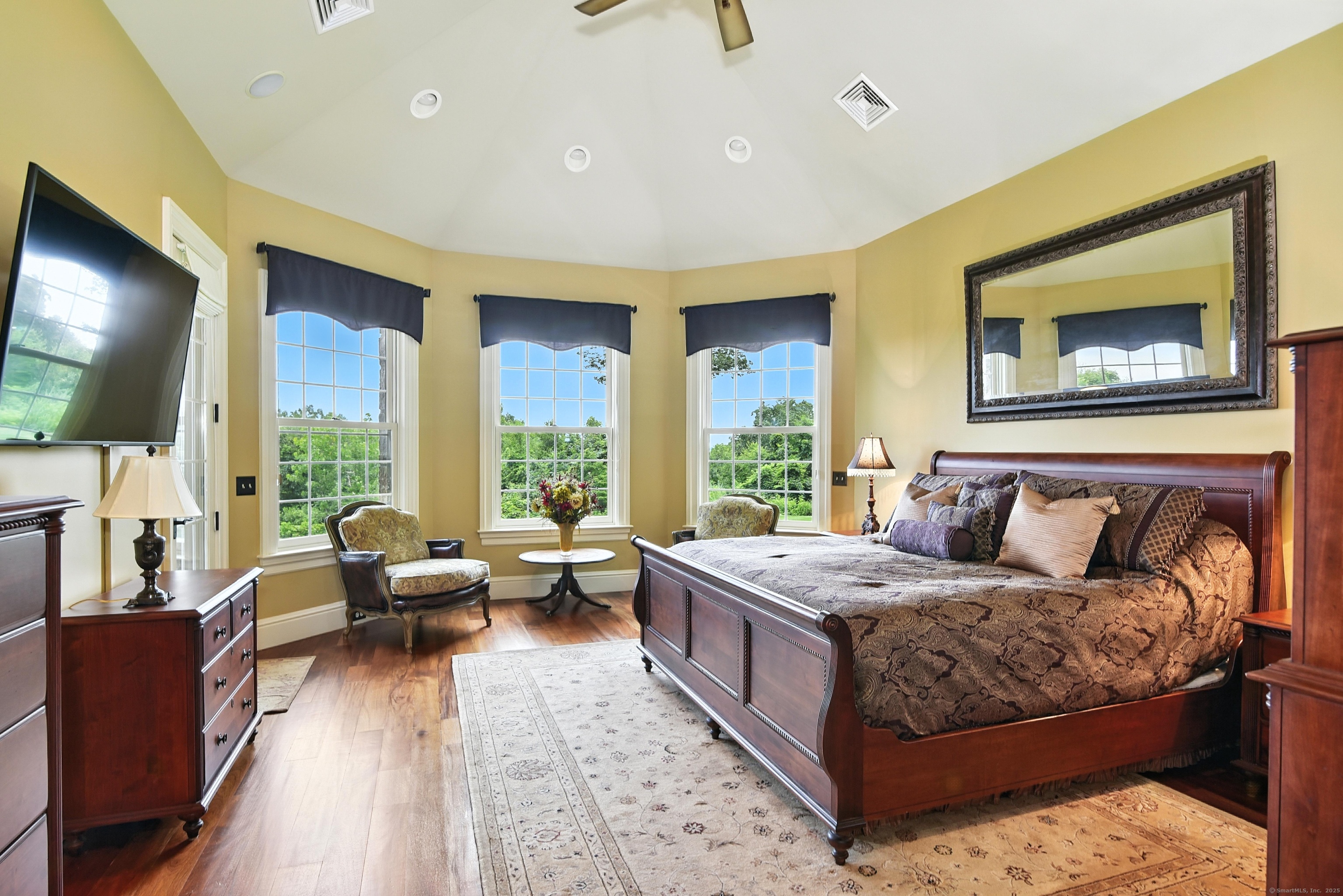 282 Searles Road Pomfret, CT 06259 - Photo 10 of 40 Soaring 15-foot vaulted ceiling. Three oversized double-hung windows with sitting area in the oversized primary bedroom.