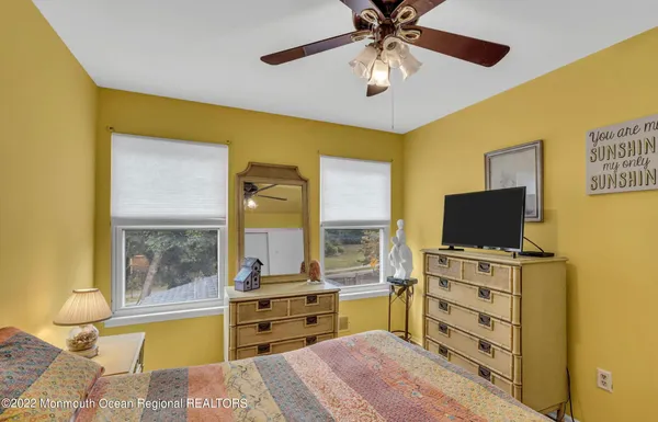a bedroom with a bed and glass door