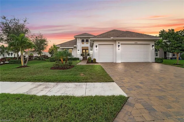 a front view of a house with a yard and garage