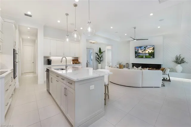 a view of a dining room with furniture window and stainless steel appliances
