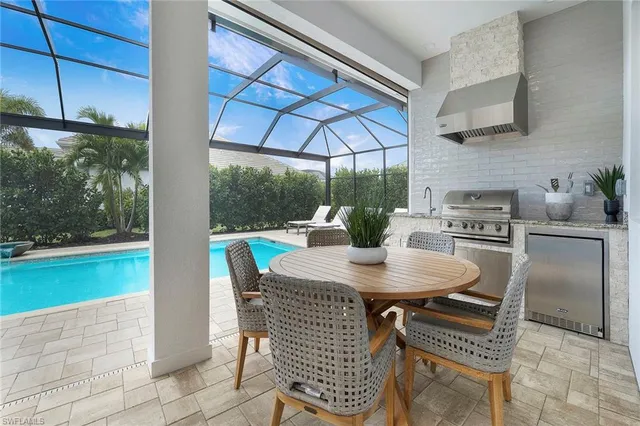 a view of a backyard with swimming pool and sitting area