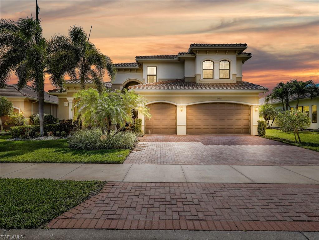 2756 Crystal Way Naples, FL 34119 - Photo 1 of 50 a front view of a house with a yard and garage