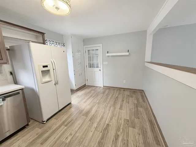 a view of a hardwood floor in a kitchen