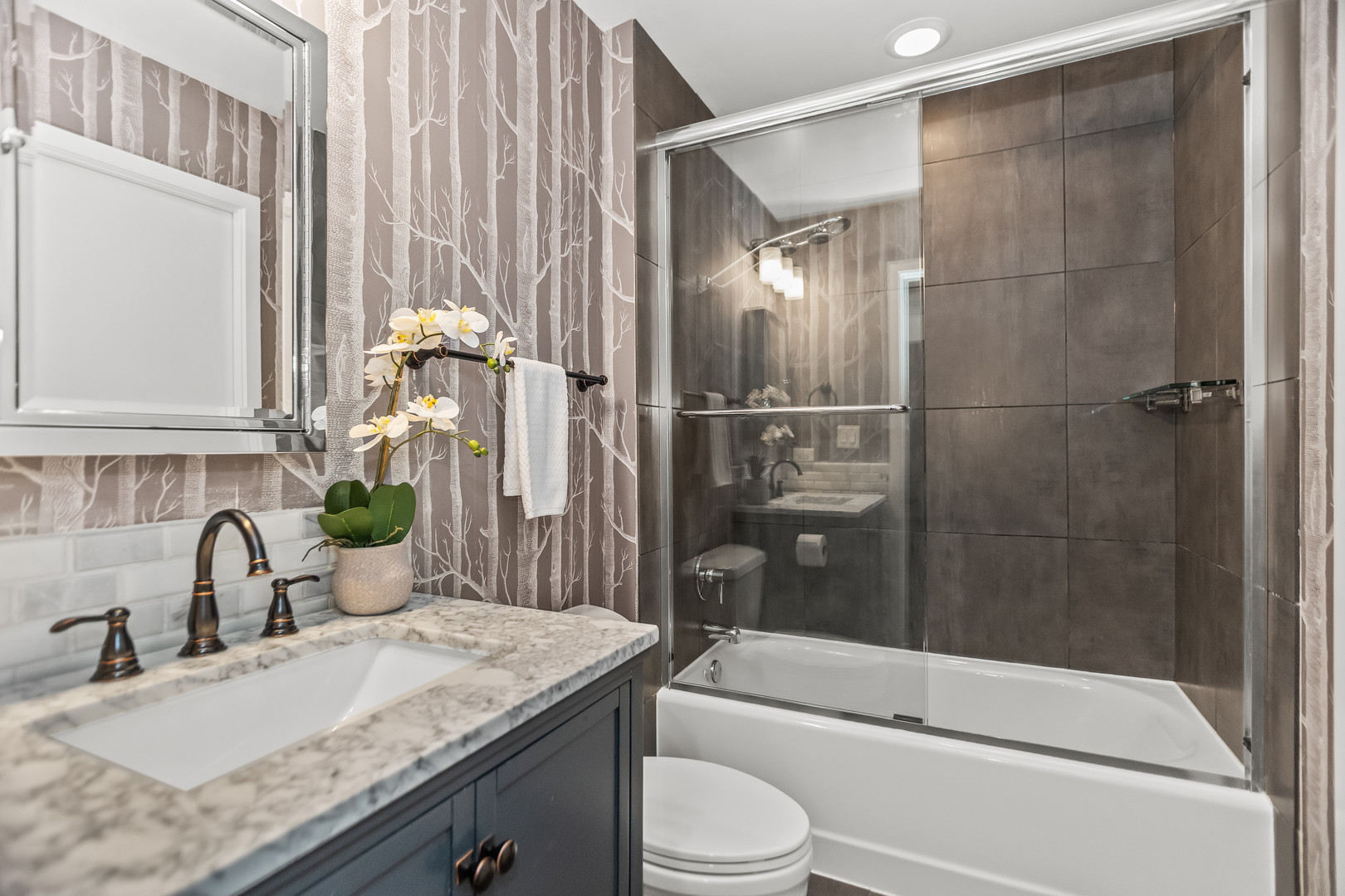 2303 South Michigan Avenue, Unit 208 Chicago, IL 60616 - Photo 13 of 21 a bathroom with a granite countertop sink a toilet and shower