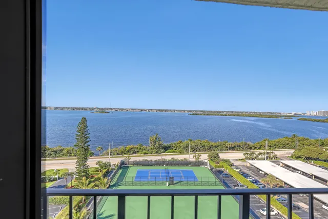 a bedroom with a bed and a flat tv screen on wall