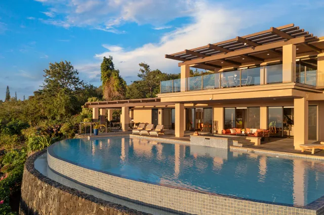 a dining room with furniture and view of a chandelier
