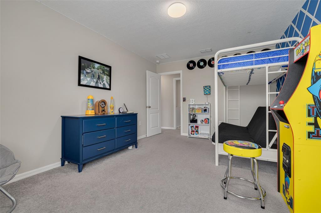 7242 Landmark Drive Spring Hill, FL 34606 - Photo 37 of 45 a room that has a bed and a chair in it