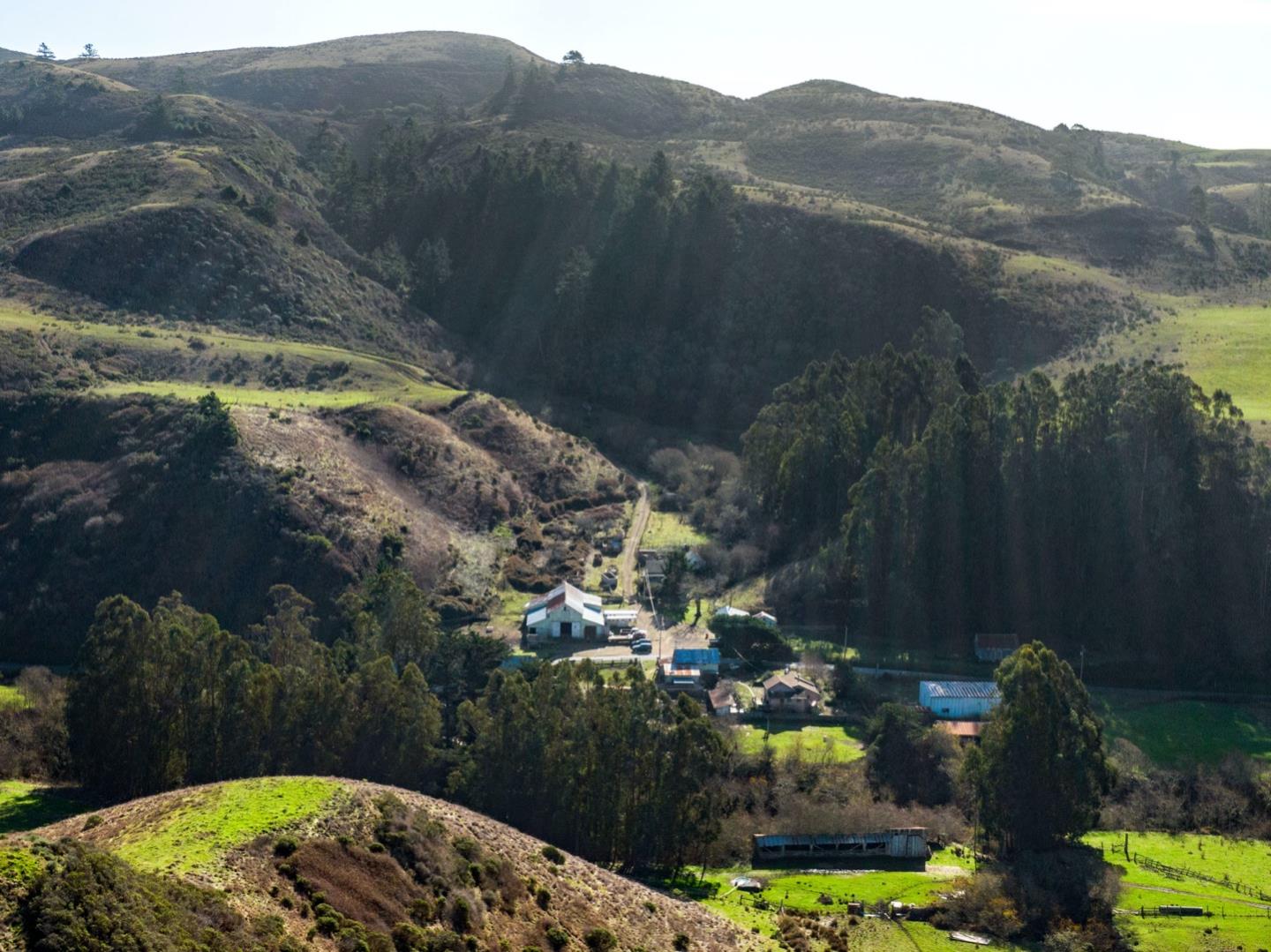 an aerial view of a house with a mountain