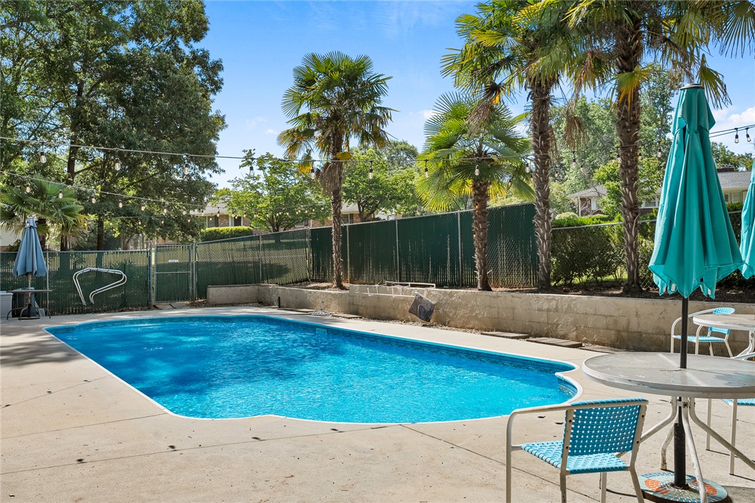 2101 Old Spring Drive Anderson, SC 29625 - Photo 24 of 36 A private pool oasis awaits, surrounded by lush trees and ample patio space for relaxation.