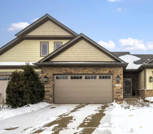 a view of a house with a snow in the yard