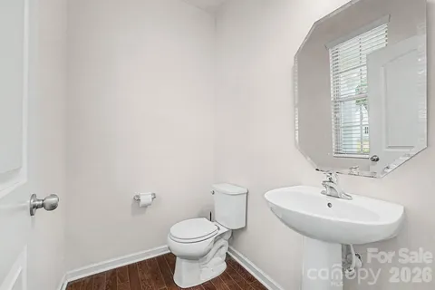 a bathroom with a sink a toilet and mirror