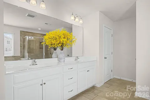 a bathroom with a double vanity sink and a mirror