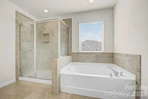 a bathroom with a bathtub and shower