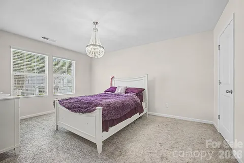 a spacious bedroom with a bed and window