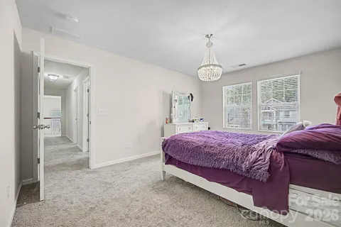 a spacious bedroom with a bed and a window
