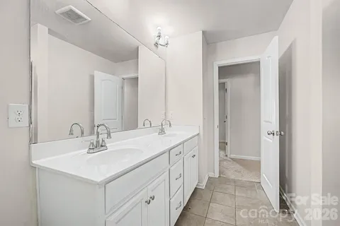 a bathroom with a sink double vanity and a mirror