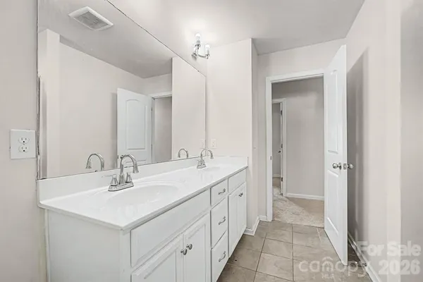 a bathroom with a sink double vanity and a mirror