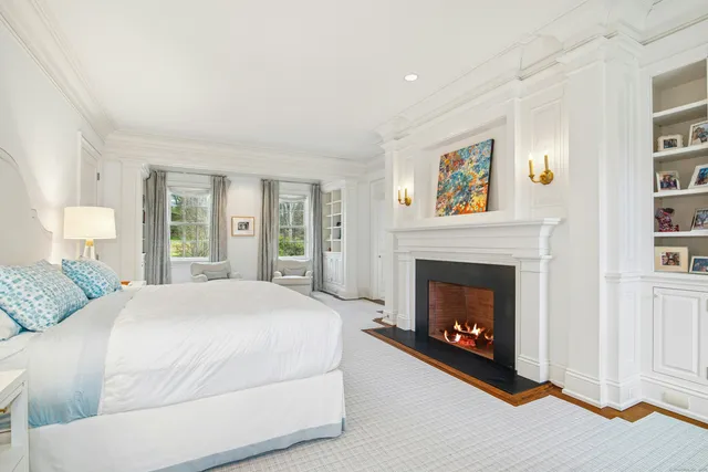 a bedroom with a bed and a fireplace