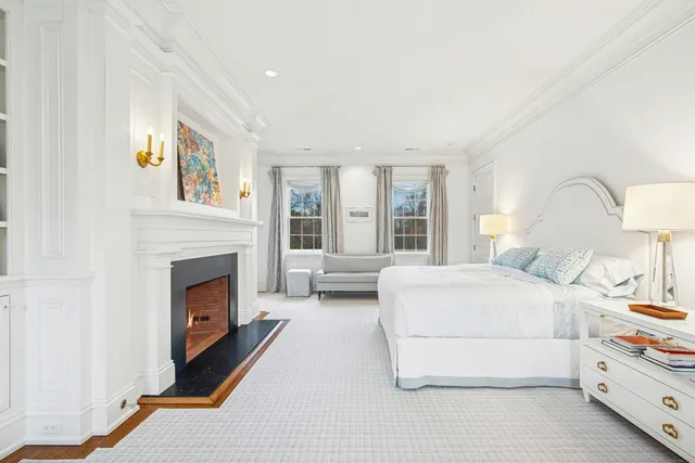 a spacious bedroom with a bed and a fireplace