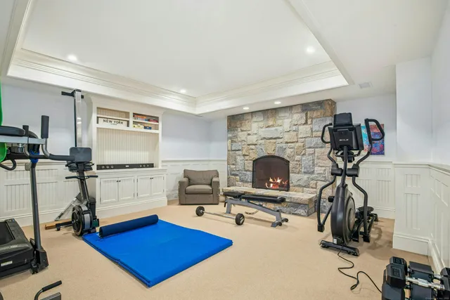 a living room with furniture a pool table and a fireplace