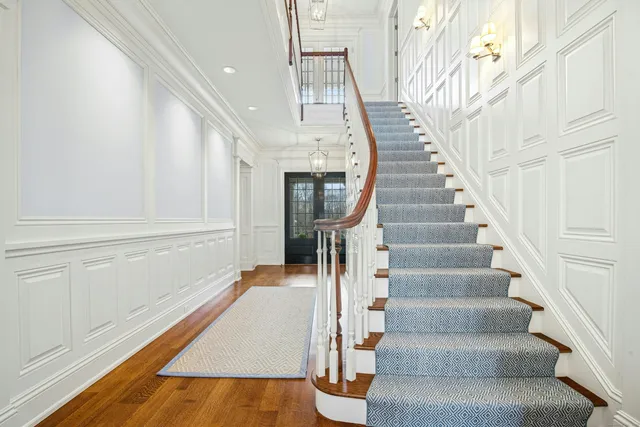 a view of staircase with white walls and railing