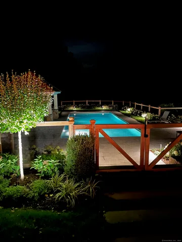 a view of swimming pool with outdoor seating and yard