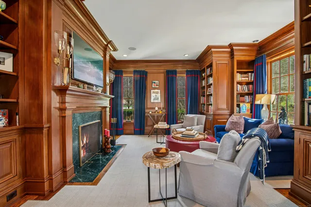 a living room with furniture a fireplace and a large window