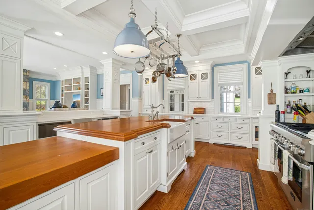 a large kitchen with kitchen island a large counter space a sink and stainless steel appliances