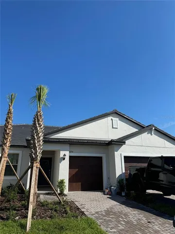 a front view of a house with plants