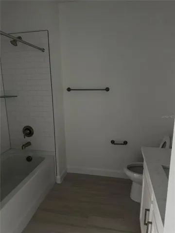 a bathroom with a bathtub and toilet