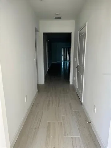 a view of a hallway with wooden shelves