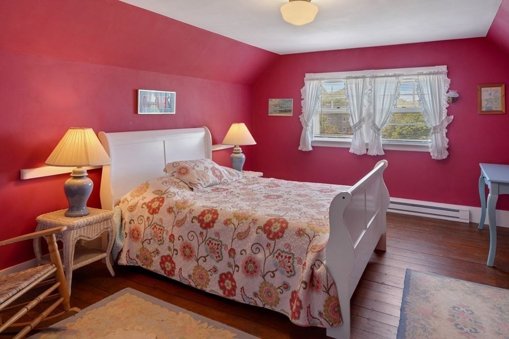 7 Bass Rocks Road Gloucester, MA 01930 - Photo 24 of 36 a bedroom with a bed and wooden floor