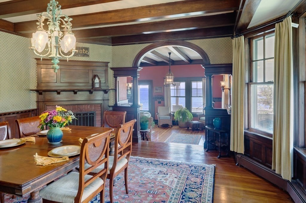 7 Bass Rocks Road Gloucester, MA 01930 - Photo 5 of 36 a dining room with furniture a chandelier and wooden floor