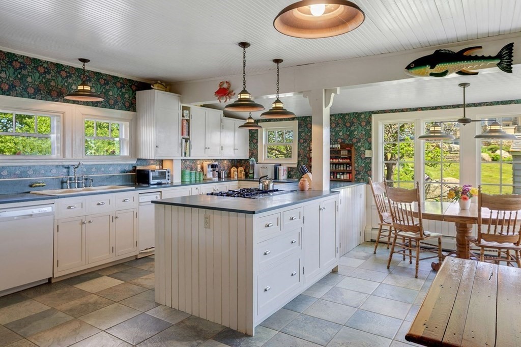 7 Bass Rocks Road Gloucester, MA 01930 - Photo 7 of 36 a kitchen with granite countertop a sink and white cabinets