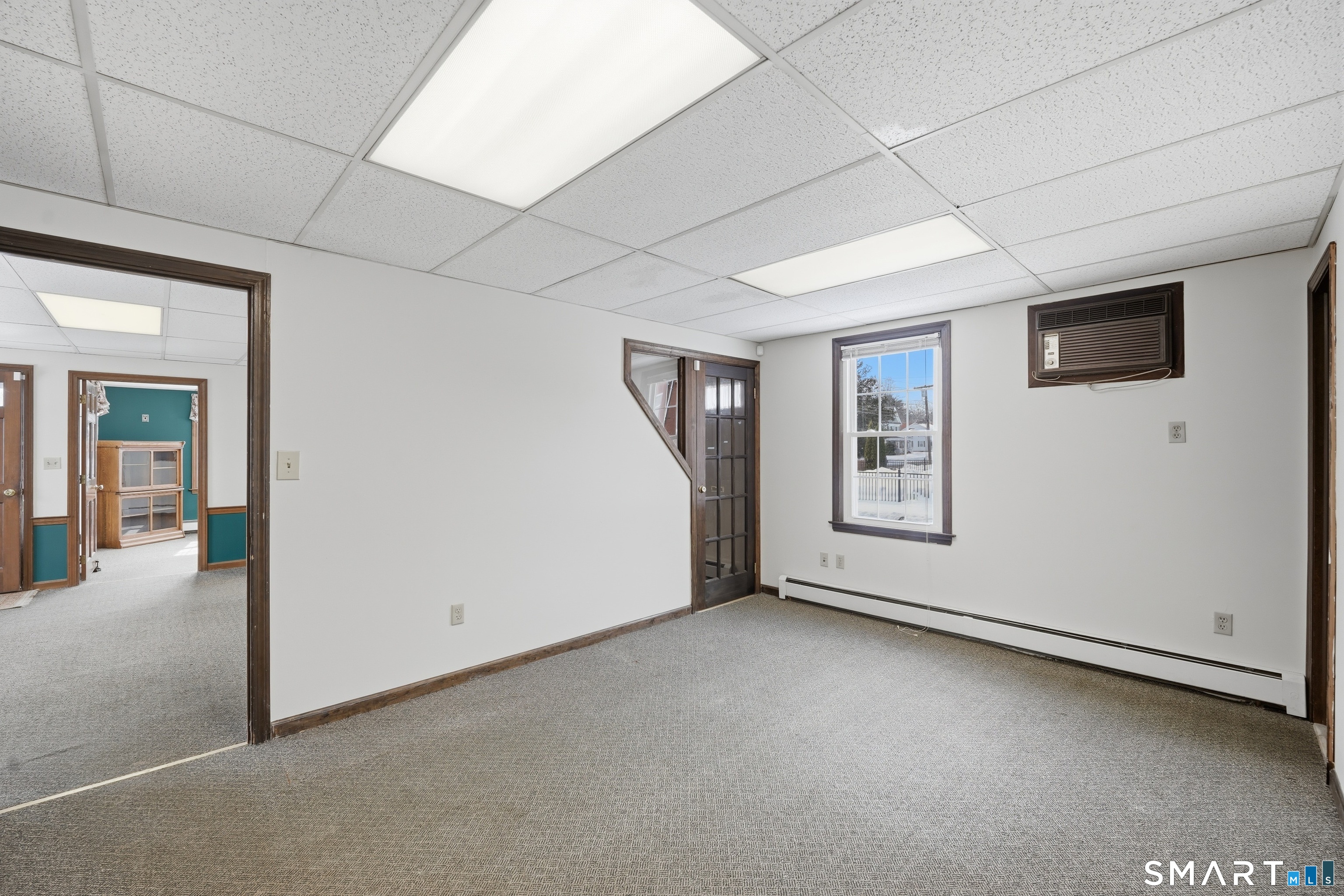66 Maple Avenue Windsor, CT 06095 - Photo 23 of 38 a view of a livingroom with an empty space and a window