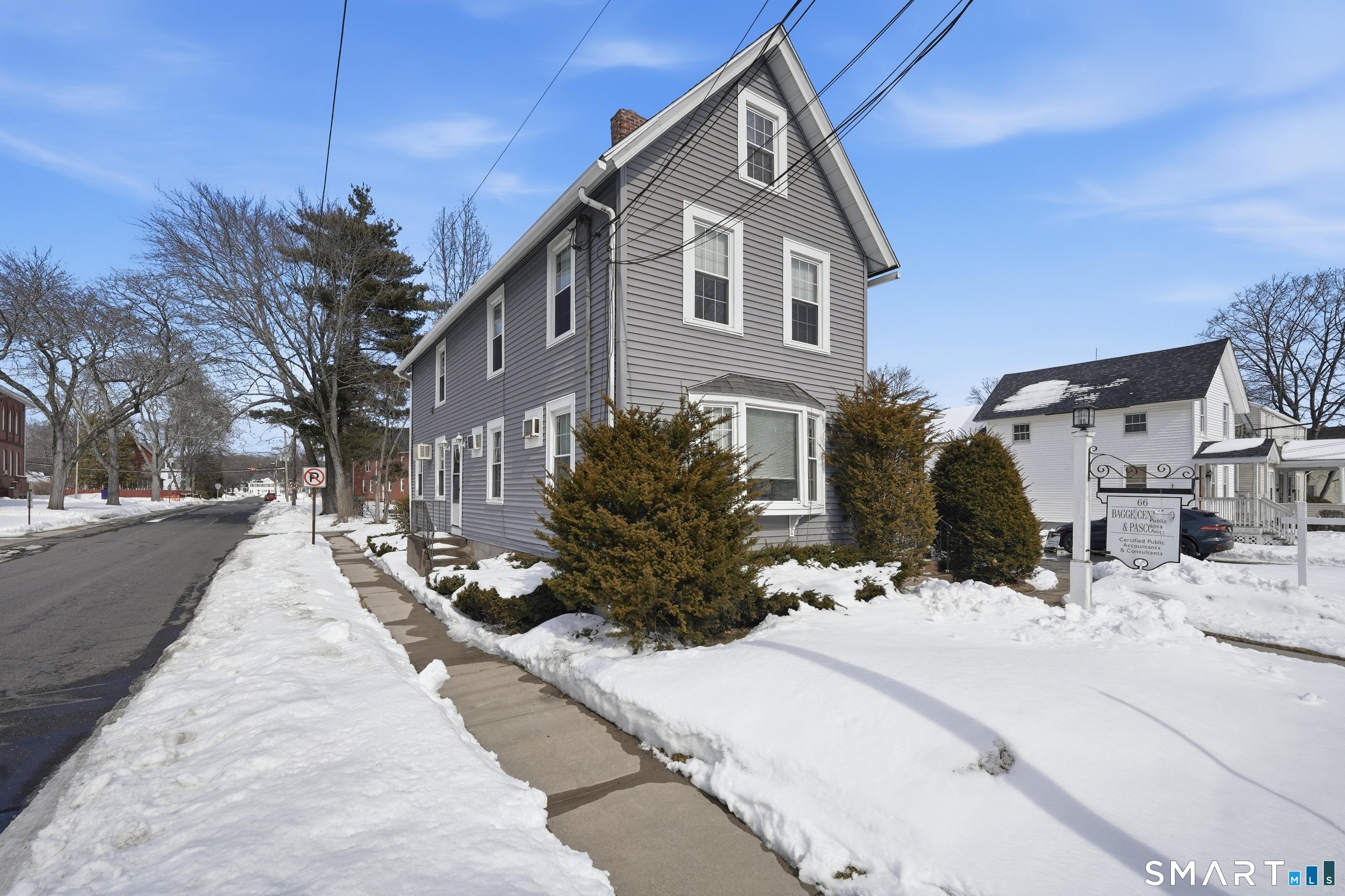 66 Maple Avenue Windsor, CT 06095 - Photo 3 of 38 a view of a house with a yard covered in snow