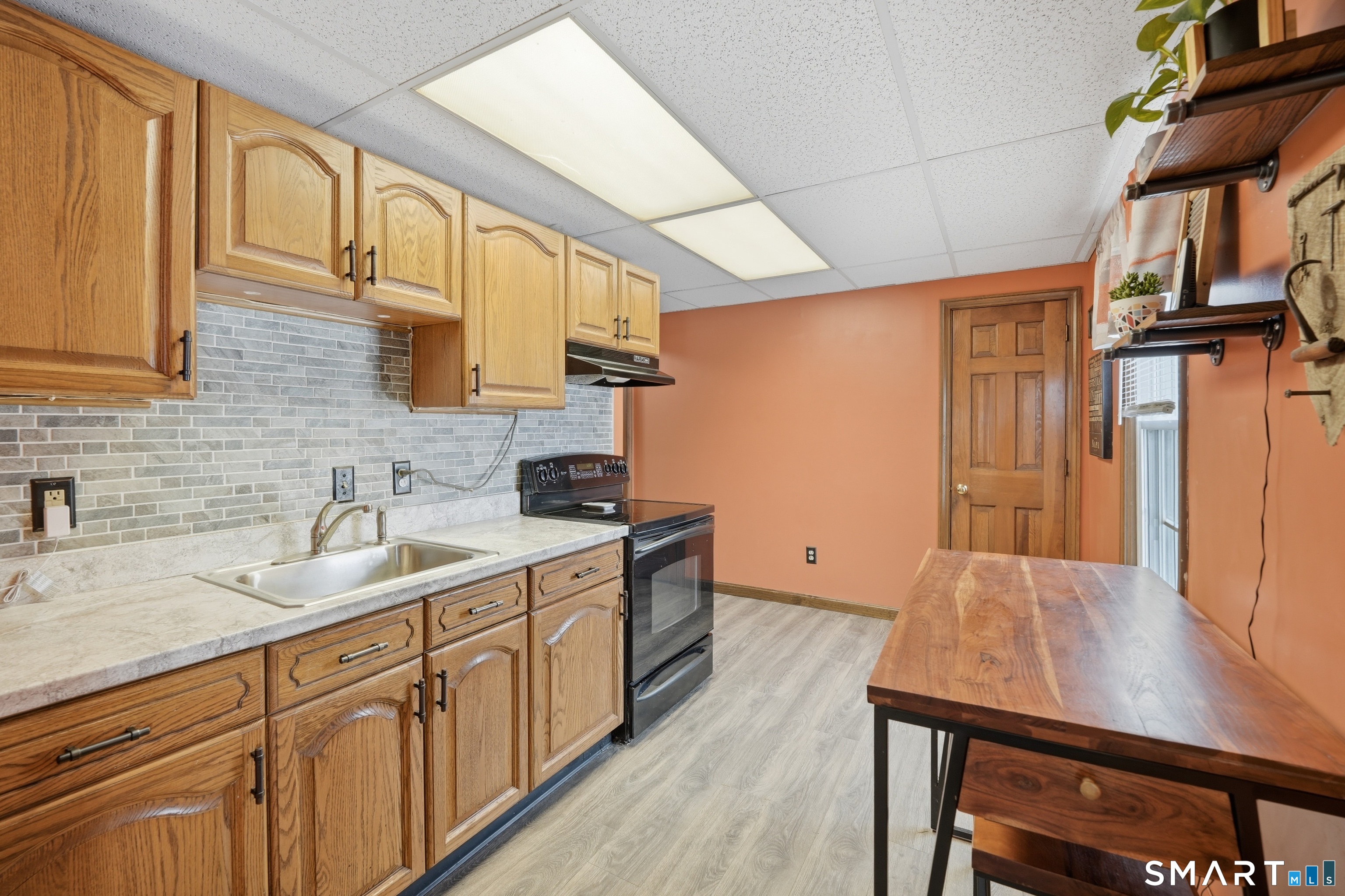 66 Maple Avenue Windsor, CT 06095 - Photo 9 of 38 a kitchen with stainless steel appliances granite countertop a sink a stove cabinets counter space and a window