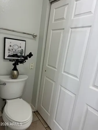 a white toilet sitting next to a shower