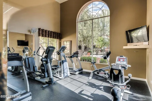 a room with gym equipment and windows