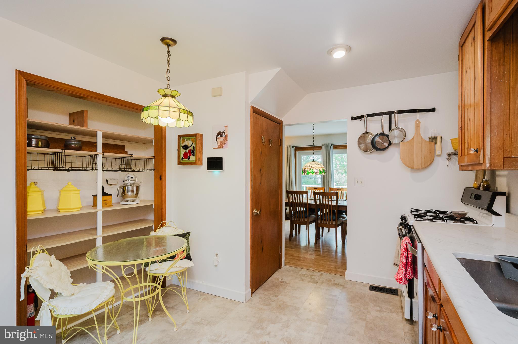 710 Magnolia Road Joppa, MD 21085 - Photo 10 of 58 a view of a dining room and livingroom with furniture wooden floor a chandelier