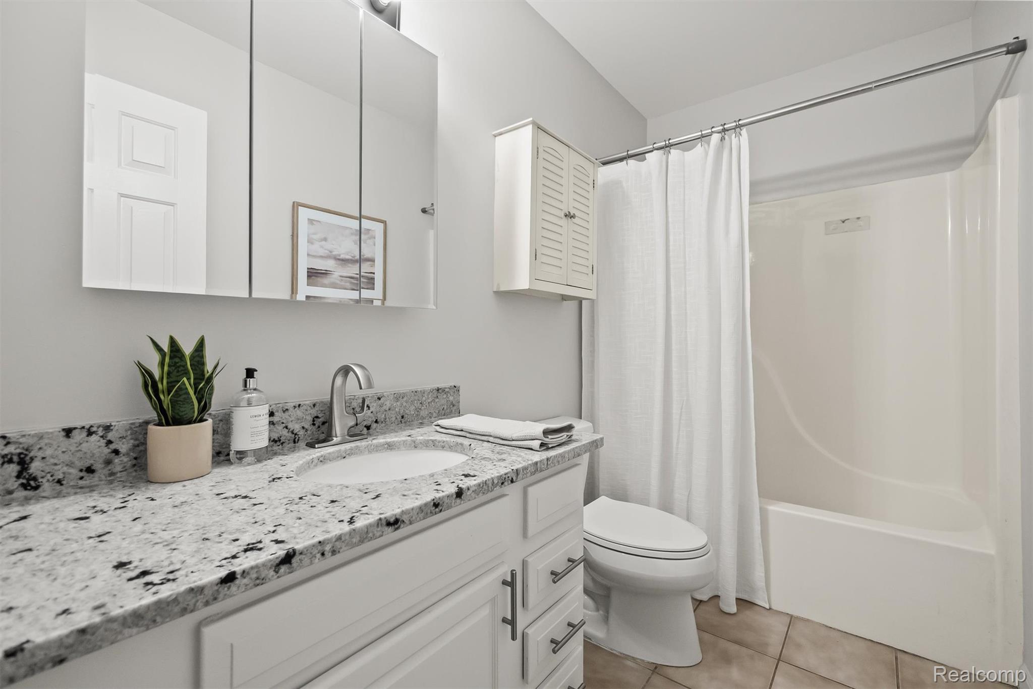 4427 Hannan Road Wayne, MI 48184 - Photo 16 of 33 White vanity with cabinet storage, speckled countertop, and integrated sink